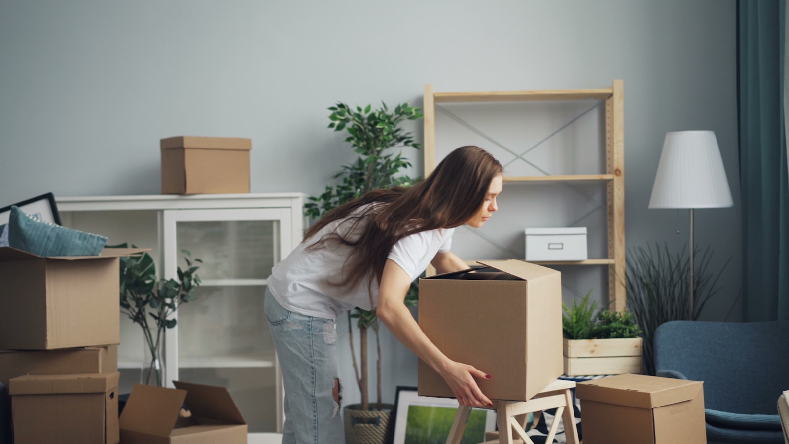A room mid-move with packed boxes being carefully handled